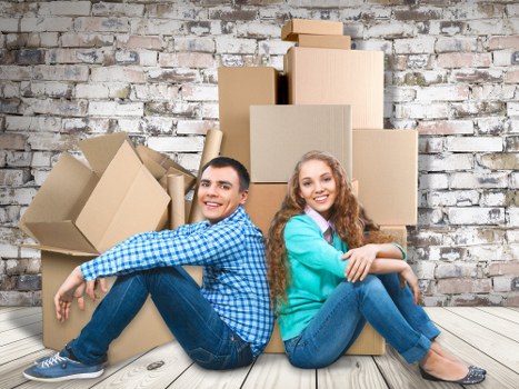 Professional movers handling furniture in an Ealing home