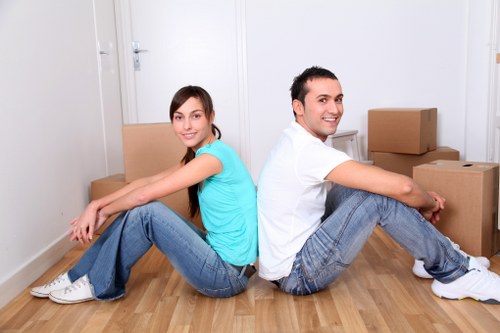 Loading household items into a van for transport in Ealing